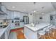 Modern kitchen with stainless steel appliances, light gray cabinets and large marble countertop island at 125 Pier View St # 408, Charleston, SC 29492