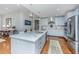 Spacious kitchen featuring white cabinets, marble countertops, stainless appliances and modern pendant lighting at 125 Pier View St # 408, Charleston, SC 29492