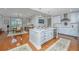 Open concept kitchen with white cabinets, marble countertops, and stainless appliances leading to dining area at 125 Pier View St # 408, Charleston, SC 29492