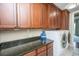 Functional laundry area featuring dark granite countertops, storage cabinets, washer, and dryer hookups at 125 Pier View St # 408, Charleston, SC 29492
