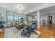 Bright living room with hardwood floors, comfortable seating, and plantation shutters open to dining room at 125 Pier View St # 408, Charleston, SC 29492