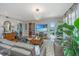 Bright living room featuring hardwood floors, modern lighting, comfortable seating, and access to an outdoor balcony at 125 Pier View St # 408, Charleston, SC 29492