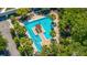 Aerial view of the luxurious community pool surrounded by palm trees and lounge chairs at 125 Pier View St # 408, Charleston, SC 29492