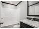 Modern bathroom featuring a shower-tub combination, sleek vanity with white countertop, and dark wood accents at 1326 Givhans Rd, Ridgeville, SC 29472