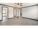 Spacious bedroom featuring multiple doorways, ceiling fan, and contemporary wood flooring at 1326 Givhans Rd, Ridgeville, SC 29472
