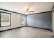 Neutral bedroom with large windows, modern ceiling fan, and wood-look flooring at 1326 Givhans Rd, Ridgeville, SC 29472