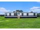 Charming manufactured home showcasing a well-manicured lawn and classic architectural details at 1326 Givhans Rd, Ridgeville, SC 29472