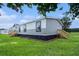 Manufactured home with a wood stair entrance and attractive gray and white siding at 1326 Givhans Rd, Ridgeville, SC 29472