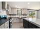 Well-lit kitchen boasts stainless steel appliances, sleek countertops, and a sink with a view at 1326 Givhans Rd, Ridgeville, SC 29472
