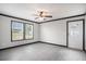 Living room with black trim, gray walls, fan, and wood-look laminate floors at 1326 Givhans Rd, Ridgeville, SC 29472