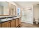 Bright bathroom featuring double vanity, spacious shower, and wood-look flooring at 1332 Givhans Rd, Ridgeville, SC 29472