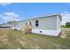 Back of home showcasing siding, a wooden staircase and a well maintained lawn at 1332 Givhans Rd, Ridgeville, SC 29472
