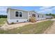 Charming single-story home featuring gray siding, white trim, and a welcoming front porch at 1332 Givhans Rd, Ridgeville, SC 29472