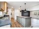 Open kitchen with stainless steel appliances, an island with grey cabinets, and hardwood floors at 1332 Givhans Rd, Ridgeville, SC 29472