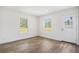 Room showcasing wood-look floors, neutral walls, windows, and a door for natural light at 1332 Givhans Rd, Ridgeville, SC 29472