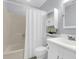 Cozy bathroom with a shower-tub combo, white shower curtain, and a mirrored vanity at 134 Hummingbird Ave, Ladson, SC 29456