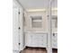 Bathroom featuring white vanity with marble top and mirror; wood-look floors at 134 Hummingbird Ave, Ladson, SC 29456