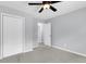 Comfortable bedroom with neutral walls, grey carpet, and closet with white bi-fold doors at 134 Hummingbird Ave, Ladson, SC 29456