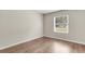 Bright bedroom featuring a window with blinds and wood-look flooring at 134 Hummingbird Ave, Ladson, SC 29456