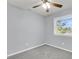 Bright bedroom featuring neutral walls, grey carpet, a ceiling fan, and a window with natural light at 134 Hummingbird Ave, Ladson, SC 29456