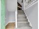Entryway with gray carpeted stairs leading to the living area and a glimpse of a stone fireplace at 134 Hummingbird Ave, Ladson, SC 29456