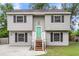 Charming split-level home features a tidy lawn, painted siding, and a bright green front door at 134 Hummingbird Ave, Ladson, SC 29456