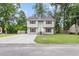 Charming two-story home with a well-manicured lawn and a paved driveway at 134 Hummingbird Ave, Ladson, SC 29456