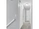Well-lit hallway featuring neutral walls, grey carpet, and white closet doors at 134 Hummingbird Ave, Ladson, SC 29456