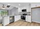 Bright kitchen with stainless steel appliances, granite countertops and light wood flooring at 134 Hummingbird Ave, Ladson, SC 29456