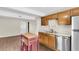Open kitchen layout featuring wood cabinets, stainless steel appliances, and wood-look flooring at 134 Hummingbird Ave, Ladson, SC 29456
