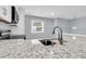 Bright kitchen featuring granite countertops, a deep sink, modern faucet, and stainless steel appliances at 134 Hummingbird Ave, Ladson, SC 29456