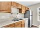 A kitchen featuring wood cabinets, a stainless steel refrigerator, and lots of counter space at 134 Hummingbird Ave, Ladson, SC 29456