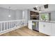 Open kitchen features white cabinets, granite countertops, and stainless steel appliances at 134 Hummingbird Ave, Ladson, SC 29456