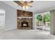 Living room features a stone fireplace, ceiling fan, and sliding glass doors leading to the deck at 134 Hummingbird Ave, Ladson, SC 29456
