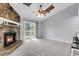 Living room features stone fireplace, ceiling fan, and sliding glass doors leading to the deck at 134 Hummingbird Ave, Ladson, SC 29456