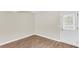 Cozy living room featuring wood-look floors and a bright white door with a window at 134 Hummingbird Ave, Ladson, SC 29456
