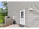 A well lit side entrance featuring vinyl siding and partial fence at 134 Hummingbird Ave, Ladson, SC 29456
