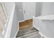 Carpeted stairway leading to a white front door with wood-look floors at the entrance at 134 Hummingbird Ave, Ladson, SC 29456