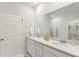 Bright bathroom boasts a double sink vanity, a large mirror, and crisp white cabinets at 140 Baldric Ct, Summerville, SC 29486