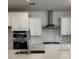 Well-lit kitchen featuring white cabinets, stainless steel appliances, and a subway tile backsplash at 124 Ireland Dr, Summerville, SC 29486
