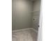 Tiled laundry room with rack and gray painted walls at 124 Ireland Dr, Summerville, SC 29486