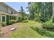 Large backyard with ample green space and mature trees with a screened in porch at 1682 Camfield Ln, Mount Pleasant, SC 29466