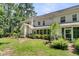 Large backyard featuring a well-manicured lawn, mature trees, and screened in porch at 1682 Camfield Ln, Mount Pleasant, SC 29466
