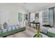 Well-lit bedroom featuring two twin beds, ensuite bathroom, and a round work desk at 1682 Camfield Ln, Mount Pleasant, SC 29466