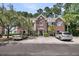 Charming brick townhomes featuring a driveway with ample parking and beautifully manicured landscaping at 1682 Camfield Ln, Mount Pleasant, SC 29466