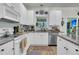 Well-lit kitchen featuring white cabinetry, granite countertops, and stainless steel appliances at 1682 Camfield Ln, Mount Pleasant, SC 29466