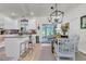 Open kitchen and dining area with an island, modern lighting, and a sliding glass door to the patio at 1682 Camfield Ln, Mount Pleasant, SC 29466