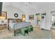 Bright main bedroom with wood floors, king bed, ensuite bathroom, and modern shelving unit at 1682 Camfield Ln, Mount Pleasant, SC 29466