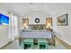 Bright main bedroom featuring a king bed, wood floors, stylish decor, and ensuite bathroom access at 1682 Camfield Ln, Mount Pleasant, SC 29466