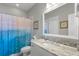 Bathroom features a marble countertop, stylish mirror, and unique shower curtain at 1722 Trewin Ct, Charleston, SC 29492